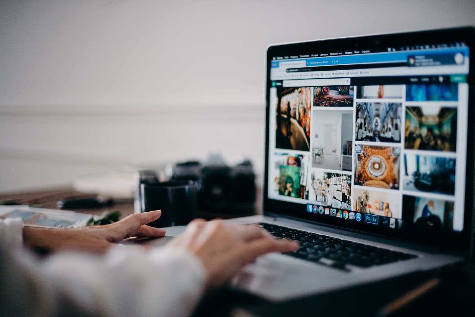 Person browsing a digital photo library on a laptop
